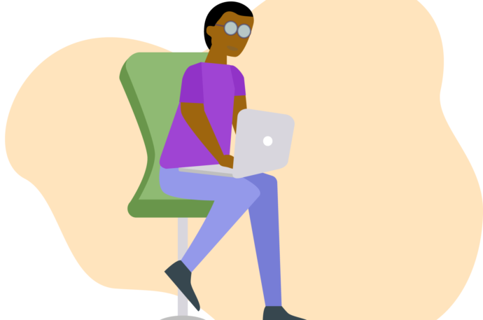 Young man sitting in a green chair using an open laptop