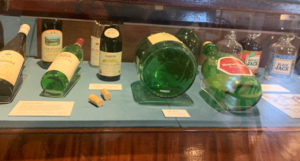 Exhibit of bottles that is difficult to see due to the angle of the lables.